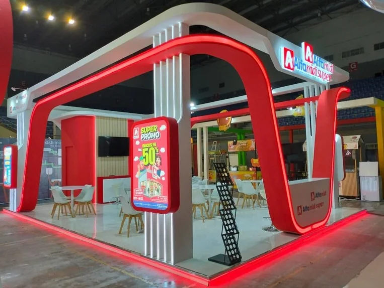 Custom booth installation with illuminated red architecture